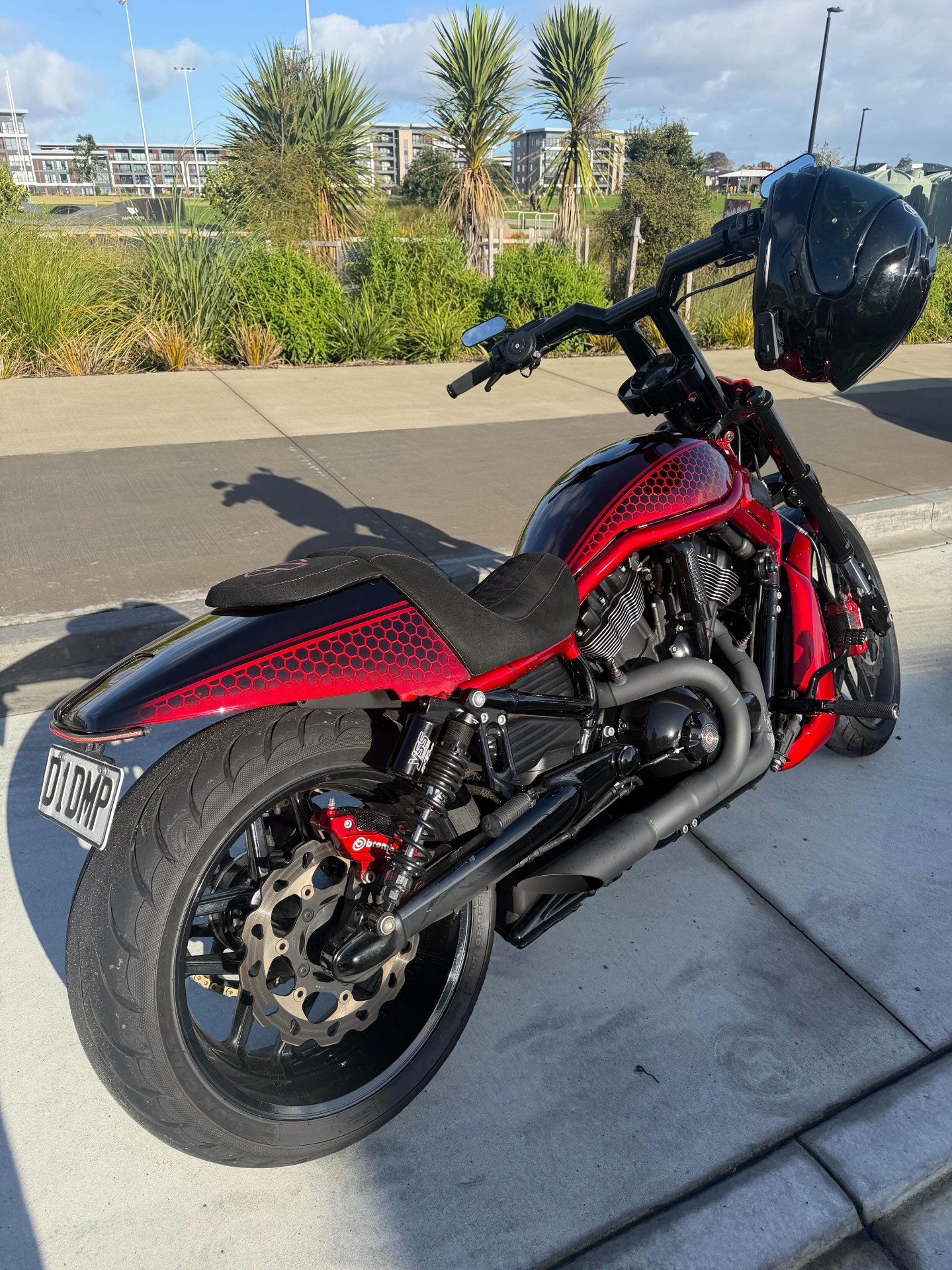 Kyle Manu's candy red and black Harley-Davidson Night Rod, rear three quarter