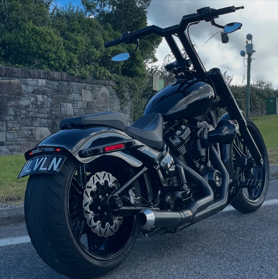 Blacked-out Harley-Davidson Softail Breakout, rear three-quarter, moody sky